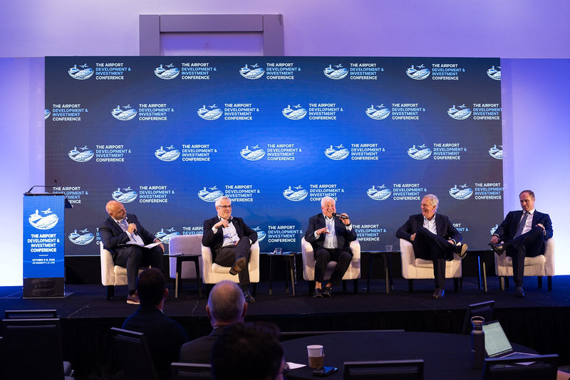 Five-speaker panel on the main stage at ADIC 2026