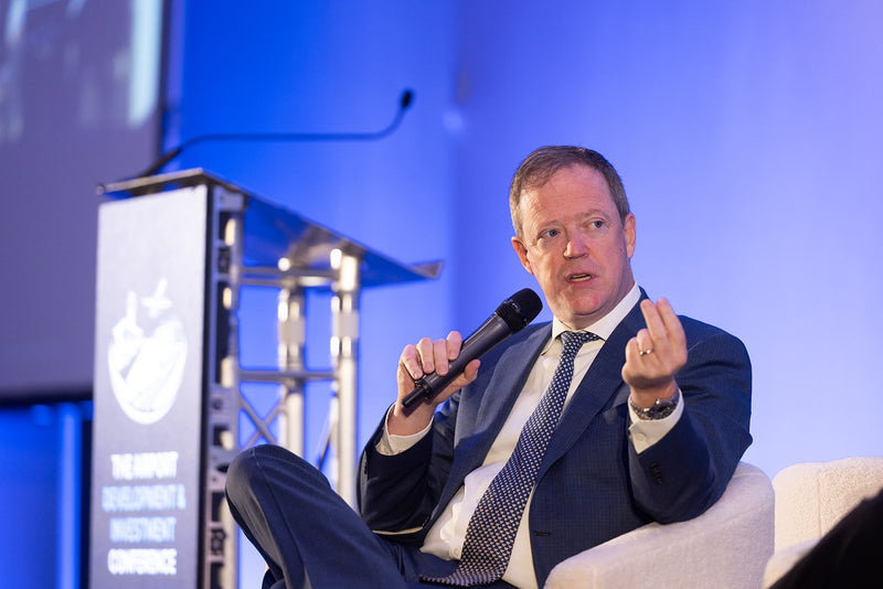 Speaker making a point during a main stage panel at ADIC 2026