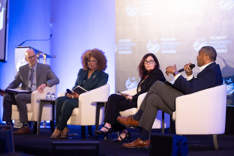 Four-person panel discussion on stage at ADIC 2026