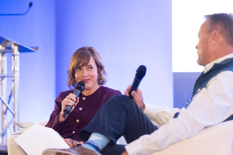 Panelists in conversation on stage at ADIC 2026