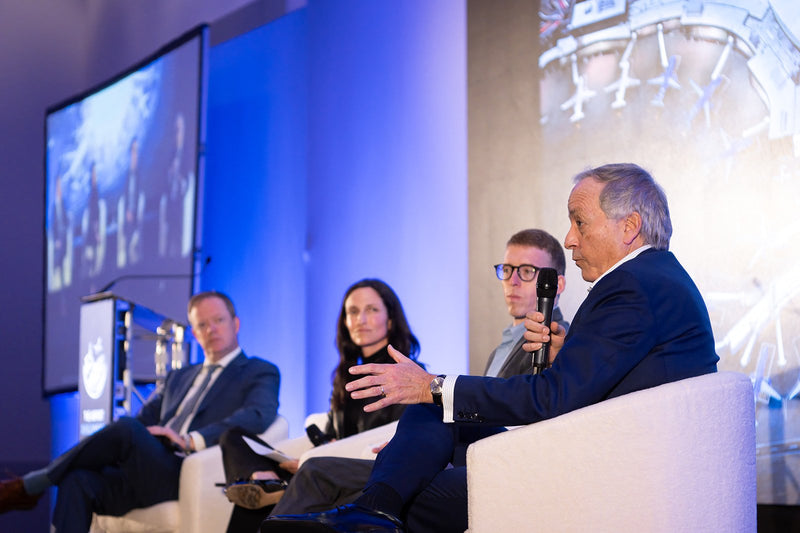Panel discussion in front of the main stage screen at ADIC 2026