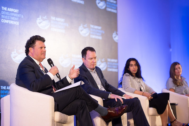 Four-person panel on stage at ADIC 2026