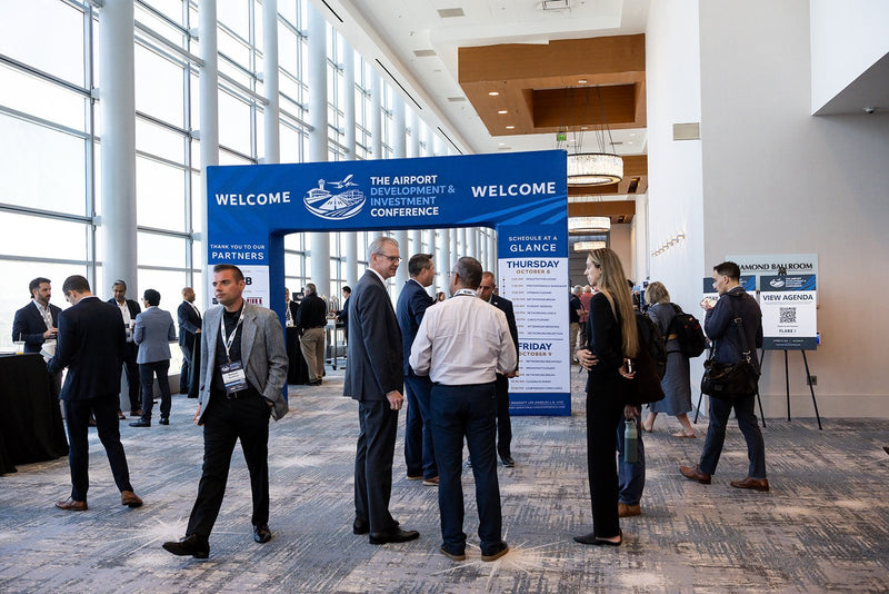 Attendees gathering at the welcome arch at ADIC 2026