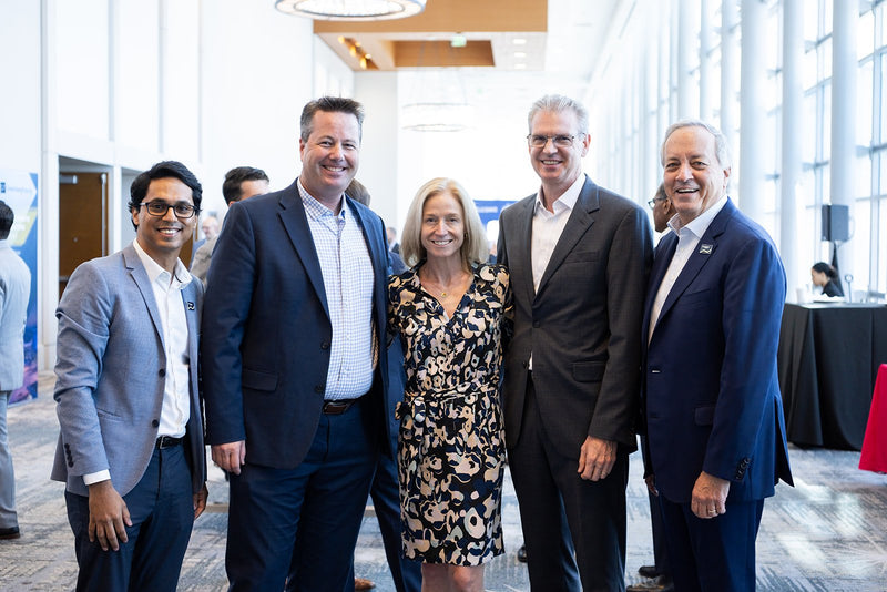 Group of attendees smiling for a photo at ADIC 2026