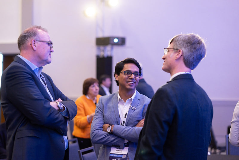 Attendees in conversation during a break at ADIC 2026