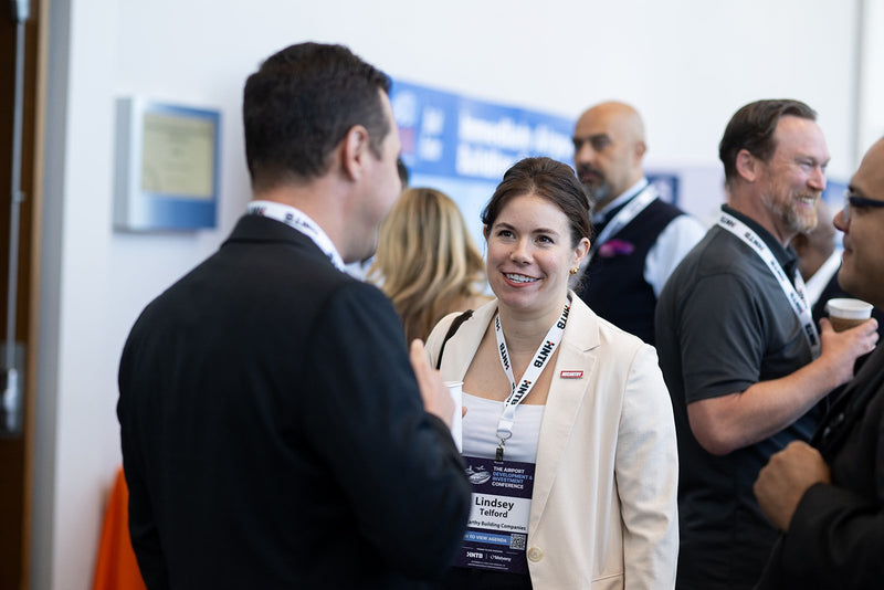 Attendees networking in the hallway at ADIC 2026