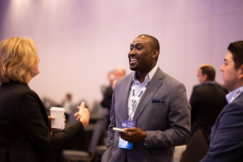 Attendee laughing during a conversation at ADIC 2026