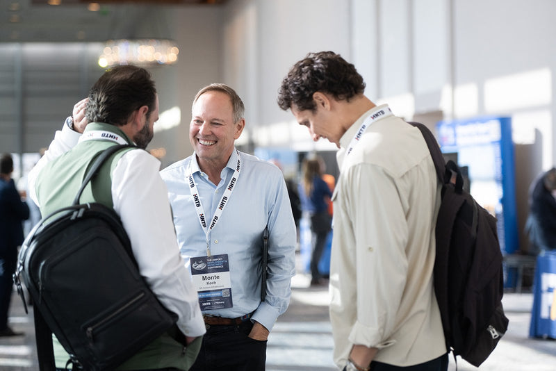 Attendees catching up in the pre-function area at ADIC 2026