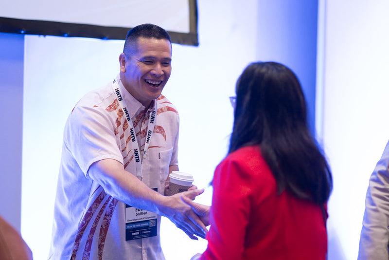 Attendees greeting each other at ADIC 2026