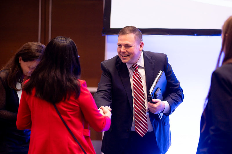 Attendees shaking hands at ADIC 2026